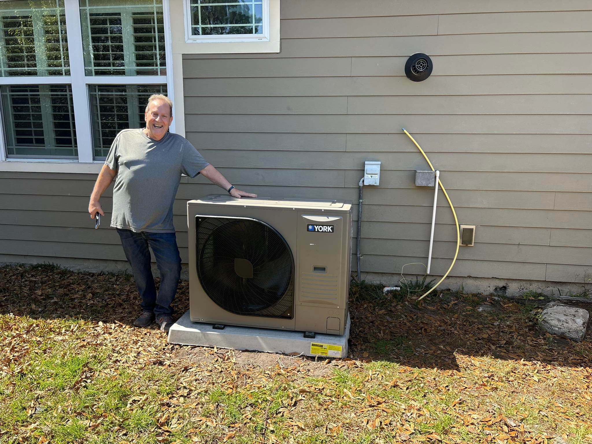Technician with freshly installed York condenser unit